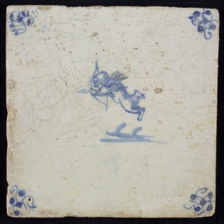 White tile with blue flying cupid with bow and arrow; corner motif spider, wall tile tile sculpture ceramic earthenware glaze