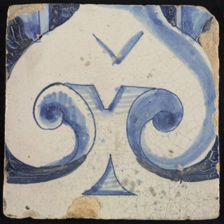 Tile of chimney pilaster, blue on white, part of capitals with stylized triangular navel and groin curls of caryatid, chimney