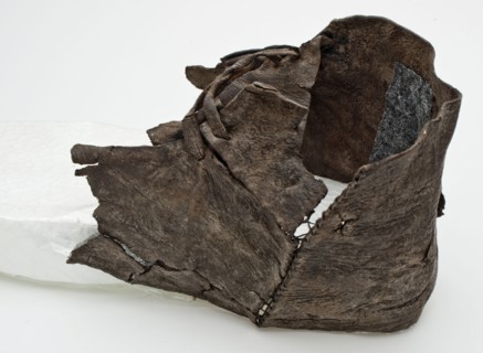 Fragment leather shoe with double leather lacing over the instep, shoe footwear clothing soil find leather, tanned cut sewn