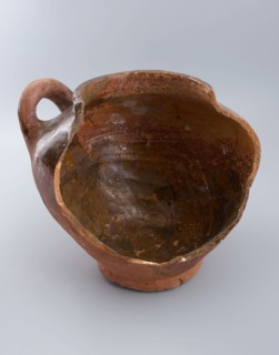 Fragment of pottery storage pot on stand, lying sausage ear, storage jar pot holder soil find ceramic earthenware glaze lead
