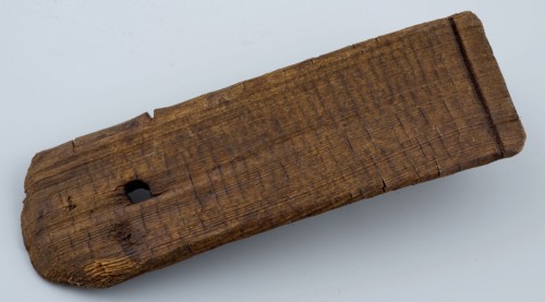 Wooden clapplate of tub with round hole for handle or rope, tons of stony foundations timber, archeology Rotterdam City center