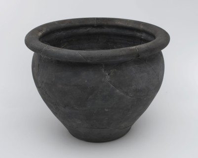 Black storage jar on standing surface, folded upper edge above constriction, storage jar pot holder soil find ceramic