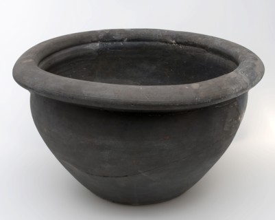 Black storage jar on standing surface, folded top edge above constriction, storage jar pot holder soil found ceramic earthenware