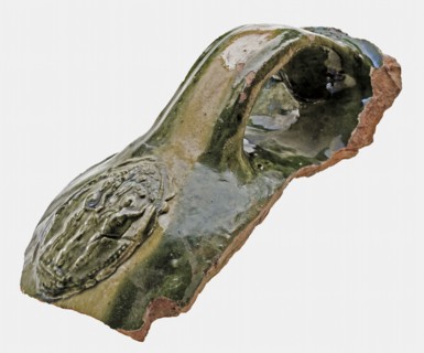 Earthenware fragment with ear and cartouche, green and yellow glazed, fire dome? fragment earthenware pottery earthenware glaze