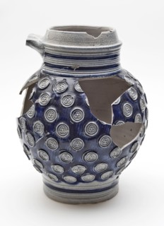 Stoneware jug decorated with small rosettes on blue background, jug crockery holder soil find ceramic stoneware glaze salt glaze