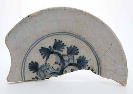 Fragment of faience plate decorated with blue decor, fruit, plate crockery holder fragment earthenware pottery earthenware glaze