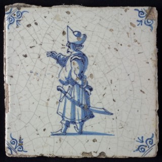 White tile with blue warrior with big belly, hat and scimitar; corner pattern ox head, two shades of blue, wall tile