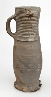 Gray stoneware jug be frowned orange flamed, jug be found on the floor ceramic stoneware, hand-turned baked coarse slightly