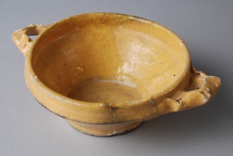 Yellow pap bowl on stand with two pinched, lobed ears, porcelain crockery holder soil find ceramic earthenware glaze lead glaze