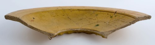 Fragment deep, yellow dish on pinched stand ring, white shard, plate dish crockery holder soil find ceramic earthenware glaze