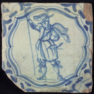 White tile with blue warrior in accolade-shaped frame; corner motif wing leaf, wall tile tile sculpture ceramic earthenware