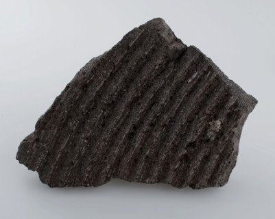 Fragment grinding stone, with circular grinding rings, millstone found in natural stone stone, split sawn chiseled Fragment