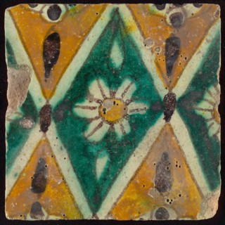 Floor tile, brown draft, green and yellow on white ground, central green oblique glass in which white flower with yellow heart