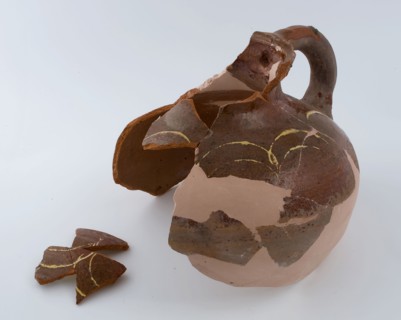 Fragment of pottery jug be applied to the shoulder with yellow arches in sludge technology, storage jar pot holder can be found