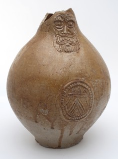 Light brown Bartmann jug, also called Bellarmine jug, under mask oval in which coat of arms, Bartmann jug jug crockery holder