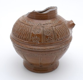 Brown stoneware jug be carved with decorative carvings and embossing with floral decoration, jug crockery holder soil find