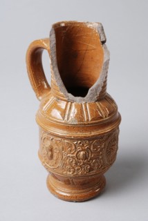 Small, brown stoneware jug with fries over the belly, jug crockery holder soil find ceramic stoneware clay engobe glaze salt