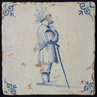 White tile with blue warrior leaning on stick; corner pattern ox head, wall tile tile sculpture ceramic earthenware glaze, baked