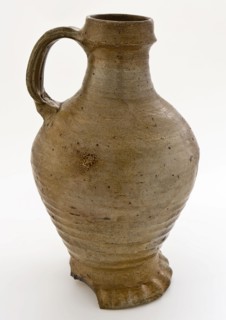 Light brown-gray stoneware jug with pinched foot, ledge around neck edge, jug crockery holder soil find ceramic stoneware clay