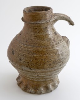 Brown stoneware jug with pinched foot, profiled edge under neck opening, ear, jug crockery holder soil find ceramic stoneware