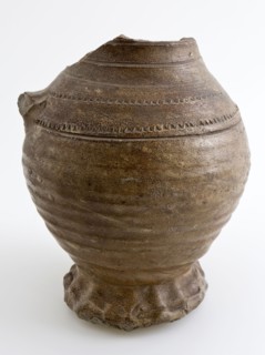 Brown stoneware jug with pinched foot, rad-stamp decoration on shoulder, jug crockery holder soil find ceramic stoneware clay