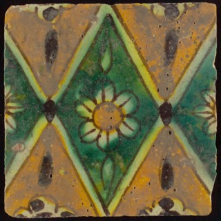 Floor tile, brown draft, green and yellow on white ground, central green oblique glass in which white flower with yellow heart