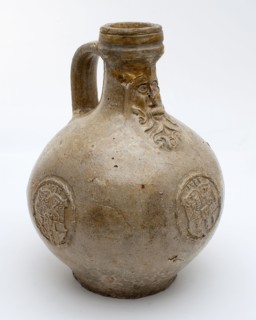 Bartmann jug, also called Bellarmine jug, gray, with mask on neck, three identical weapon medallions with date on belly