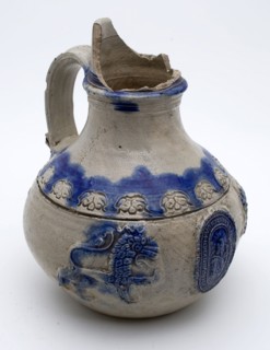 Stoneware jug, dated, lions flanked by lions on belly with border text and weapon, bulletbay pot crockery holder soil find