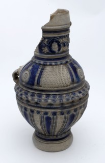 Stoneware jug with profiled frieze, shoulder with surfaces of carved cut decor, medallions on the neck, jug crockery holder soil
