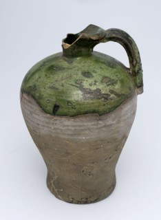 Partially green glazed gray jug with ear, narrow and protruding neck, jug holder kitchen utensils earthenware ceramics
