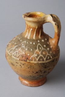 Pottery oil jug on stand with standing ear and silt decoration on the neck and shoulder, oil jug crockery holder soil find