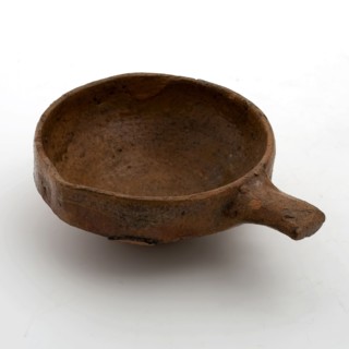 Pottery steel bowl or wine bowl with red shard and inside and outside edge covered with lead glaze with short handle and pouring