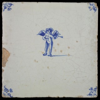 White tile with blue putto with wind instrument, ox-head in the corners, wall tile tile sculpture ceramics pottery glaze, baked
