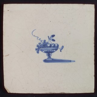 White tile with blue fruit basket, bowl on foot, wall tile tile sculpture ceramic earthenware glaze, baked 2x glazed painted