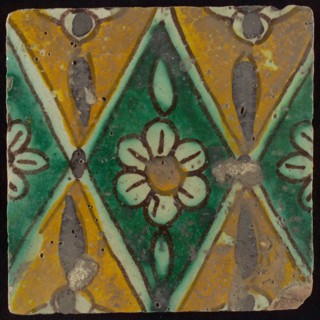 Floor tile, brown draft, green and yellow on white ground, central green oblique glass in which white flower with yellow heart