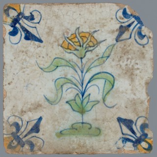 Tile, flower on ground in orange, green and blue on white, corner pattern french lily, corner point orange, wall tile