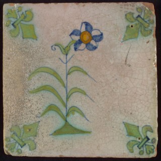 Tile, flower on ground in orange, yellow, green and blue on white, corner design french lily in green, wall tile tile sculpture