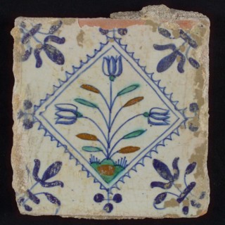 Tile, three-tier on ground in brown, green and blue on white, inside serrated squared with three-point, corner pattern french