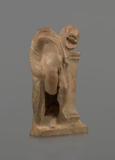 Terracotta figurine of a youth with a terracotta mask; maker, Hellenistic period 4th–1st century