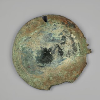 Mirror cover, The cover, with an edge bent inwards at a right angle, is decorated with concentric