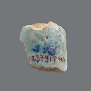 Fragment of a shabti; head of a shabti figurine with carefully rendered facial features in a smooth