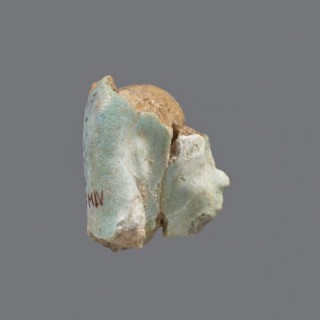 Fragment of a shabti. Head of a shabti figurine with carefully rendered facial features, in a