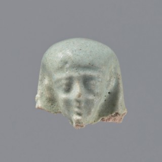 Fragment of a shabti. Head of a shabti figurine with carefully rendered facial features, in a