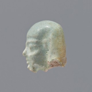 Fragment of a shabti; head of a shabti figurine with carefully rendered facial features, in a