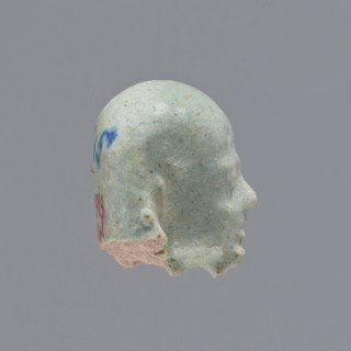 Fragment of a shabti. Head of a shabti figurine with carefully rendered facial features, in a