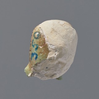 Fragment of a shabti. Head of a shabti figurine with rather carelessly rendered facial features, in
