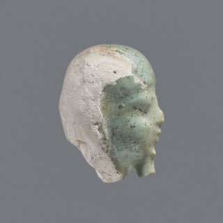 Fragment of a shabti. Head of a shabti figurine with rather carelessly rendered facial features, in