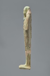 Ushabti, Mummy-shaped figurine standing on a base with the back resting on a pillar. Arms crossed