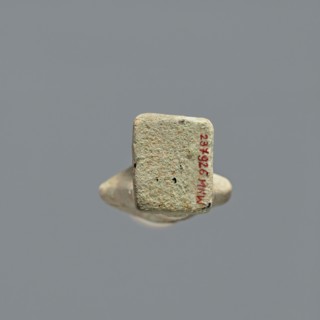 Ushabti, Mummy-shaped figurine, standing on a base, the back resting on a pillar. Arms crossed on