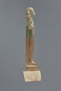 Fragment of a shabti, Mummy-shaped figurine, grave good, hoe held in hands. Upper part preserved to